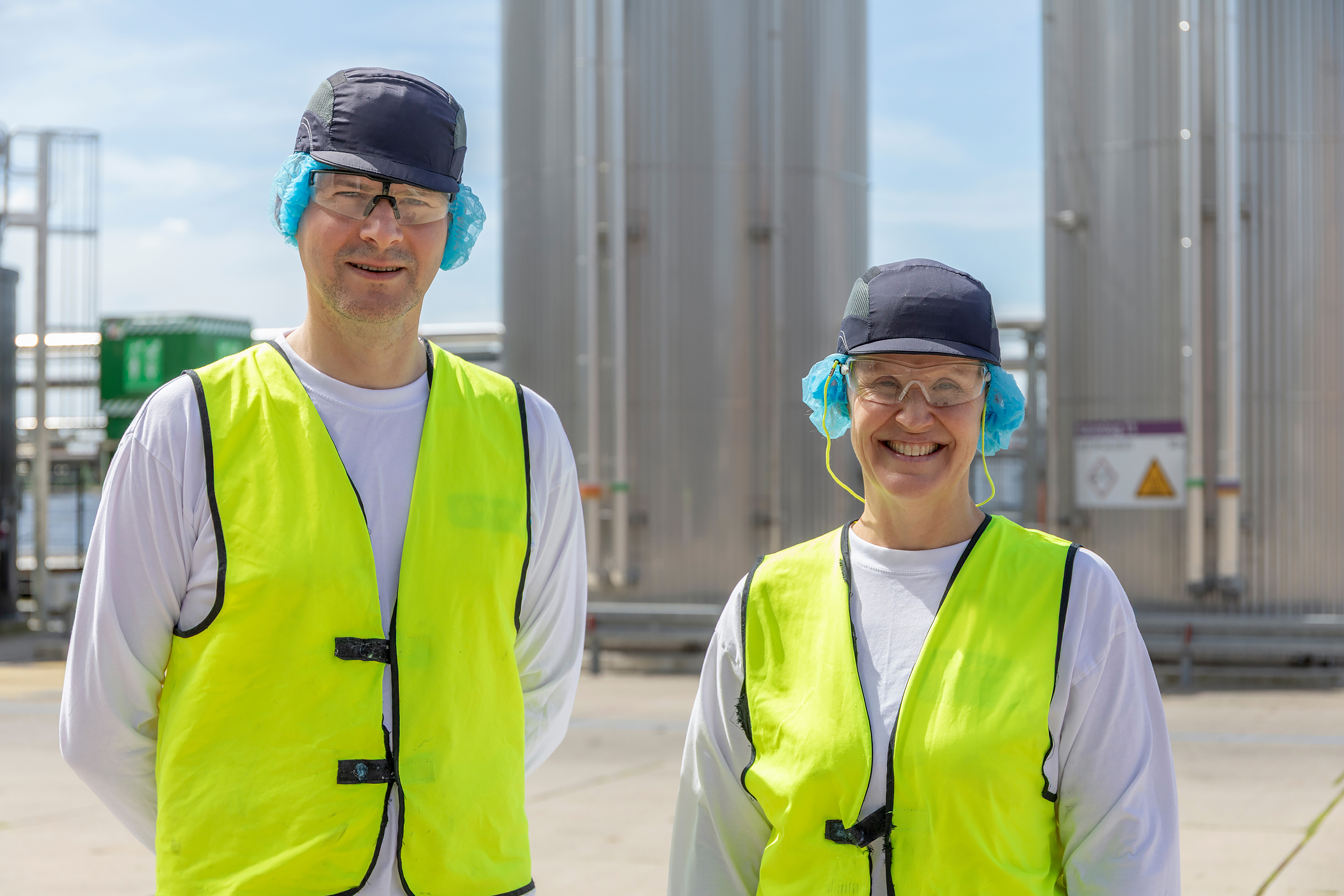 Two Vreugdenhil Dairy Foods employees by the Gpi stainless steel tanks